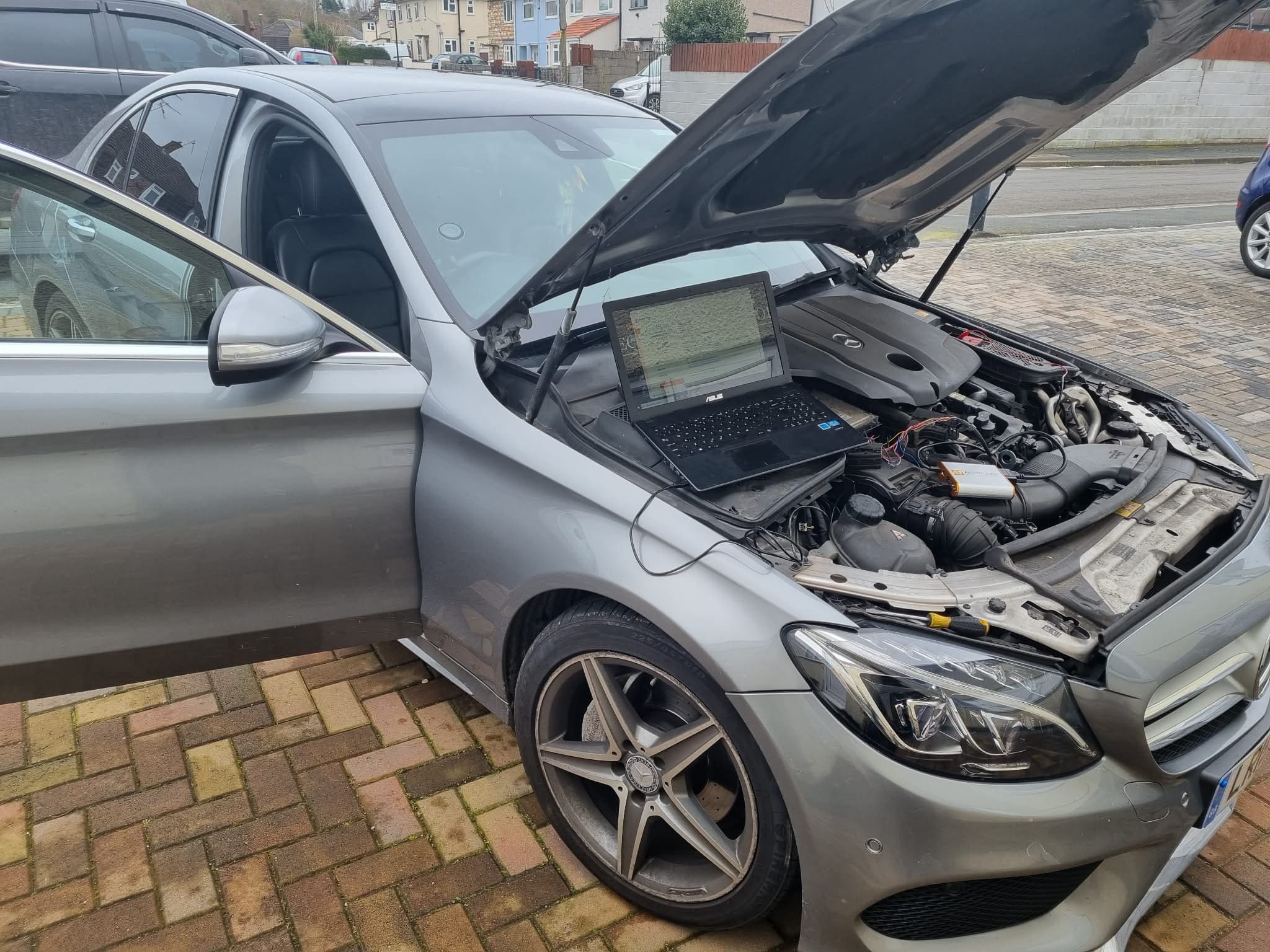 Mobile ECU remap on a Mercedes C-Class — laptop connected to engine bay at customer location